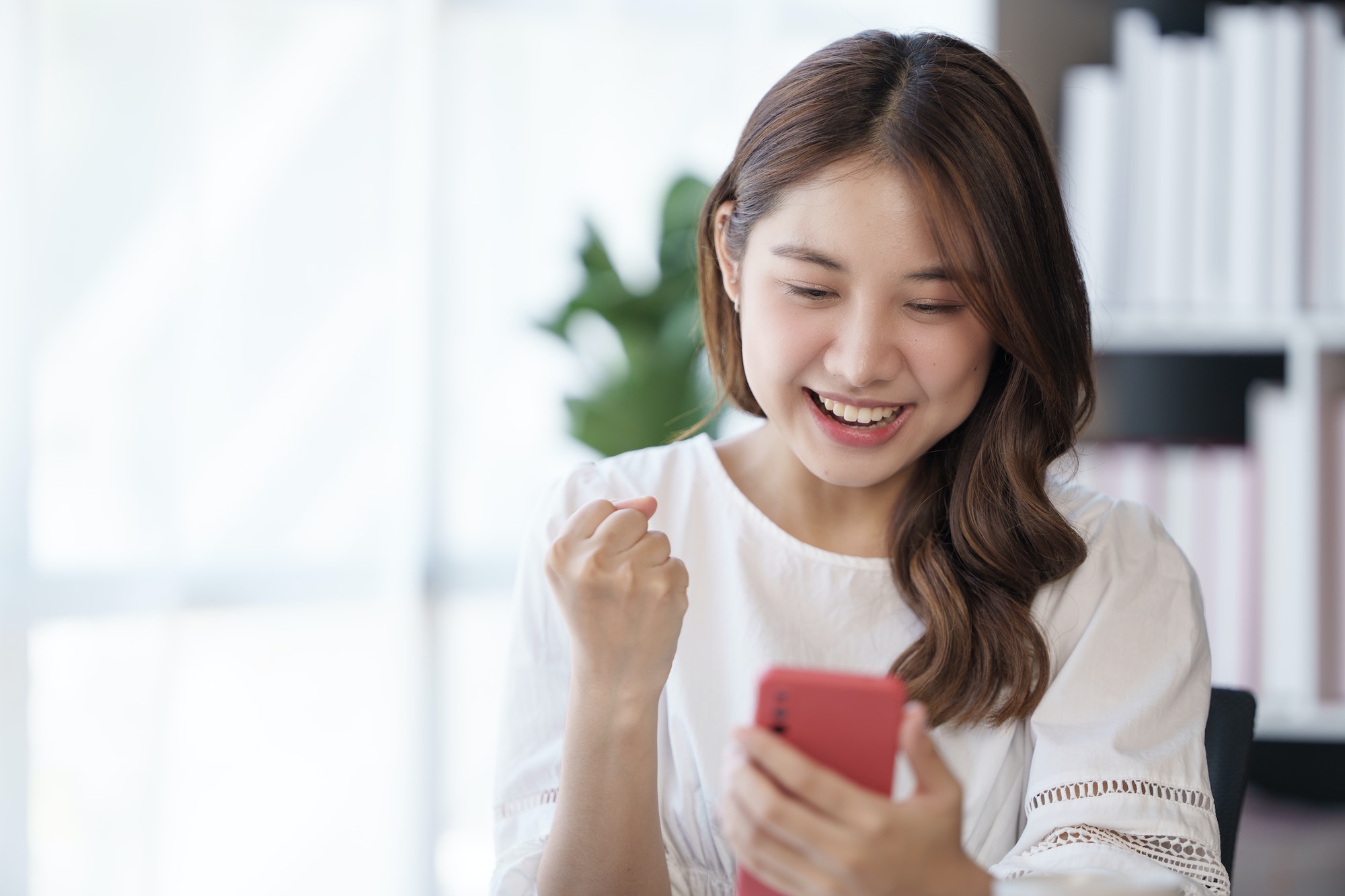 Young asian woman using a smart phone.